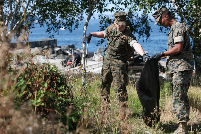 U.S. Marine Corps Sgt. Kham Siam and Corparal Tristan Sherry pick up trash at Myrtle Edwards Park for Seattle Fleet Week Aug. 3, 2024. Seattle Fleet Week is a time-honored celebration of the sea services and provides an opportunity for the citizens of Washington to meet Sailors, Marines and Coast Guardsmen, as well as witness firsthand the latest capabilities of today’s maritime services. (U.S. Navy photo by Mass Communication Specialist 3rd Class Justin Ontiveros)