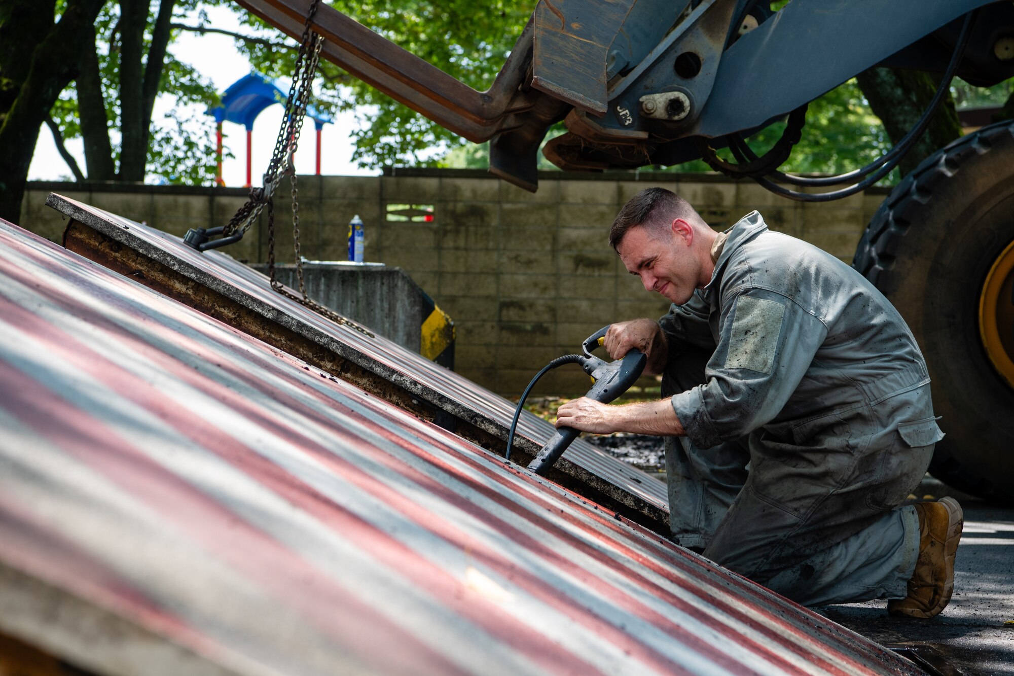 U.S. Air Force Master Sgt. Zachary Bieranowski, 374th Civil Engineer Squadron power production NCO in charge, conducts maintenance on an active vehicle barrier system at Yokota Air Base, Japan.