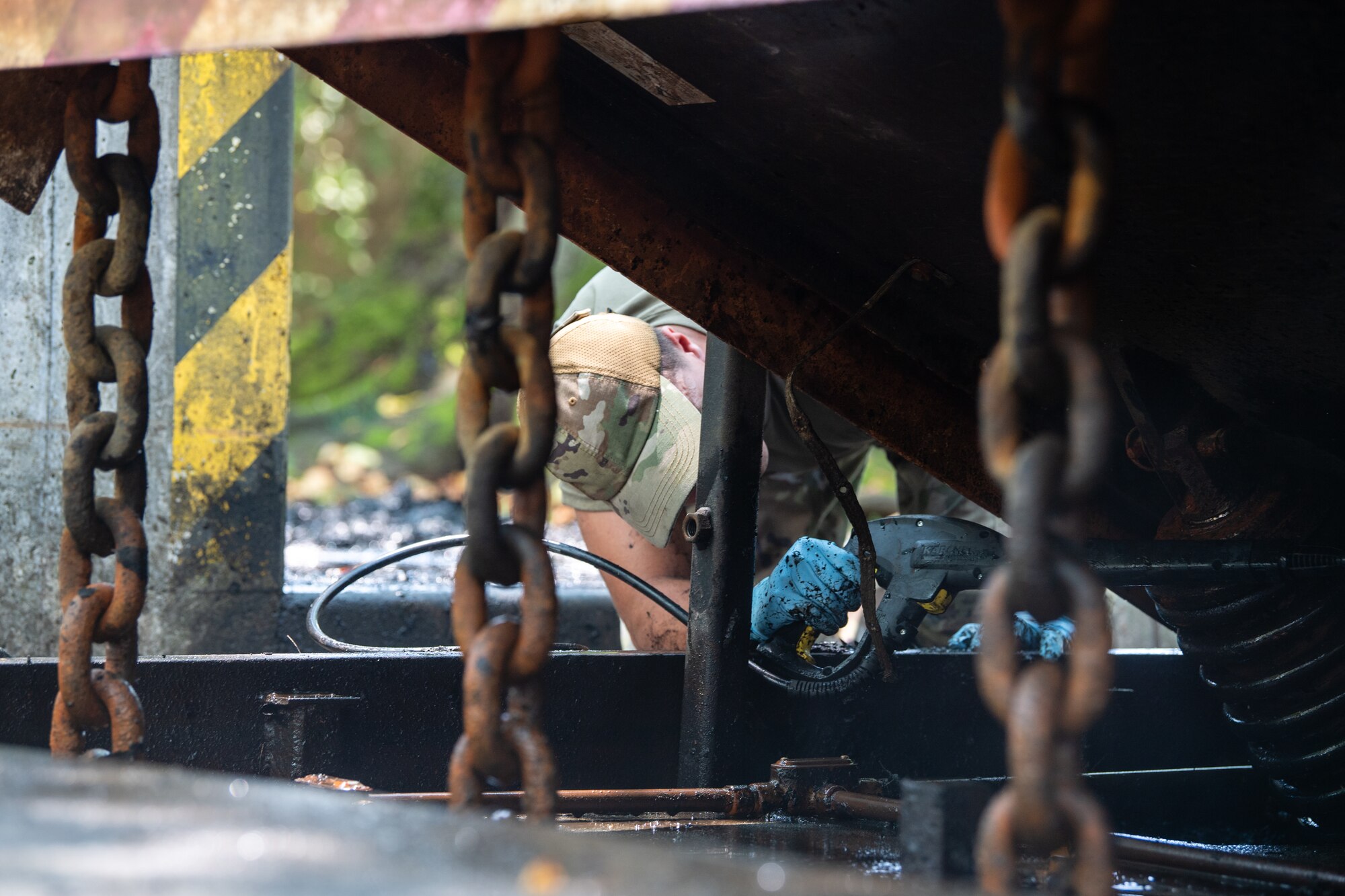 U.S. Air Force Senior Airman Branson Sutherland, 374th Civil Engineer Squadron power production journeyman, conducts maintenance on an active vehicle barrier system at Yokota Air Base, Japan.