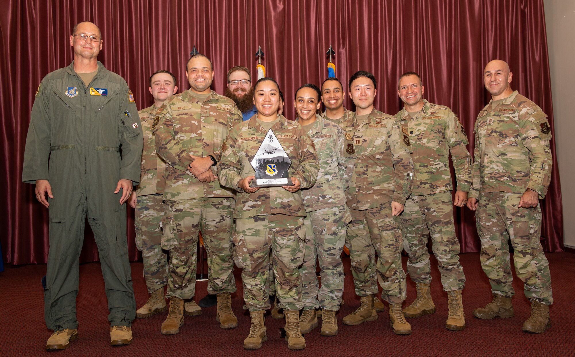 U.S. Air Force 374th Airlift Wing leadership presents an award to the aerospace ground equipment flight at Yokota Air Base, Japan.