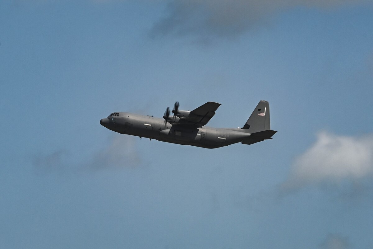 A plane flies through the sky.