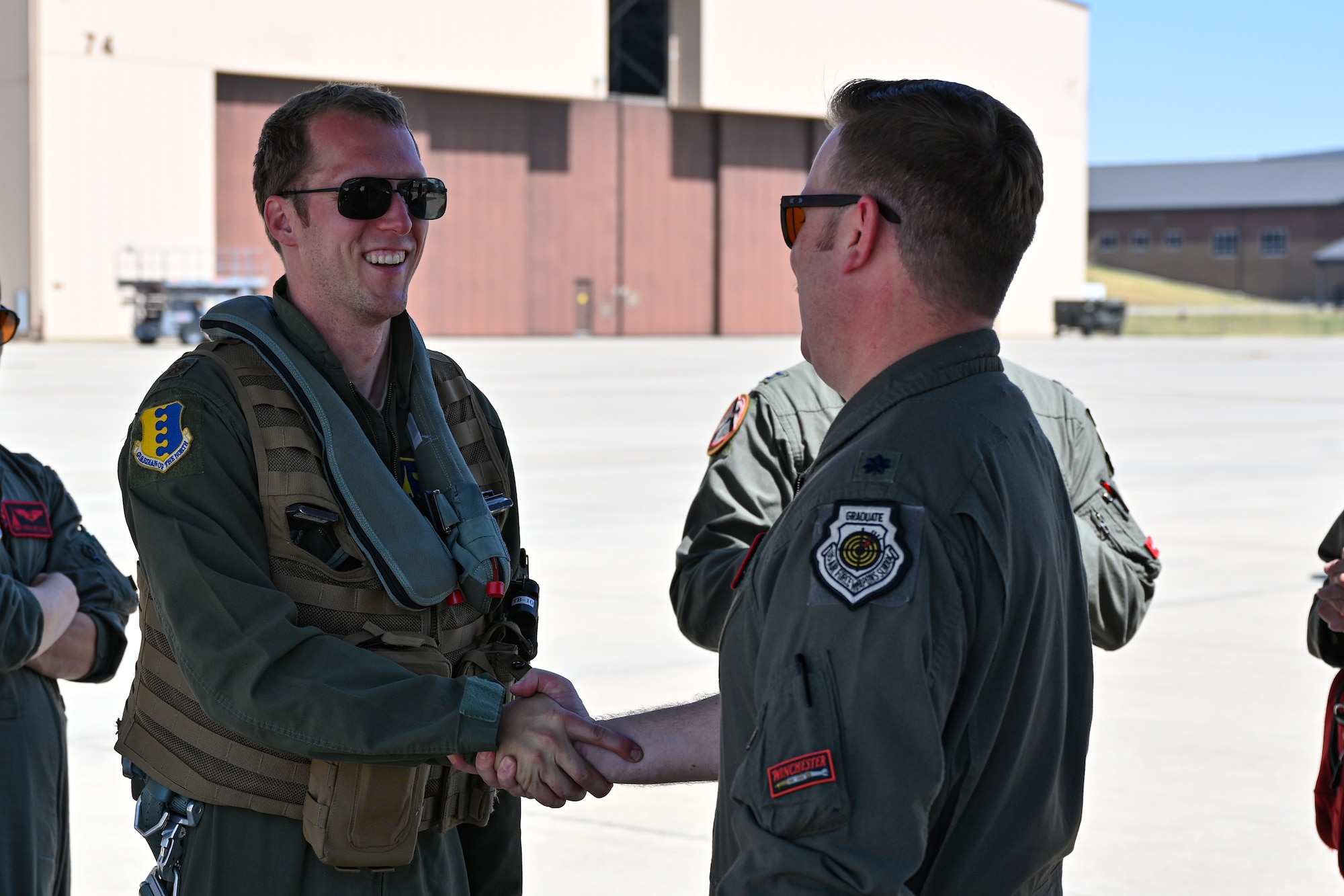 Lt. Col. Robert Wasil, 34th Bomb Squadron commander, right, shakes hands with Maj. Eric Poland, 28th Bomb Wing executive officer, returning from a CONUS-to-CONUS bomber mission at Ellsworth Air Force Base, S.D., Aug. 2, 2024. Bomber missions familiarize aircrew with air operations in different geographic areas of operations where they can respond anywhere, at any time. (U.S. Air Force photo by Staff Sgt. Jake Jacobsen)