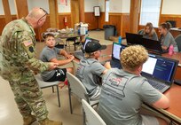 U.S. Soldiers with the Pennsylvania National Guard Cyber Branch host 13 students aged 11-18 from the Pequea Valley School District Apple Core Team for a day of learning and competition at Fort Indiantown Gap, Pennsylvania, Aug.1, 2024.