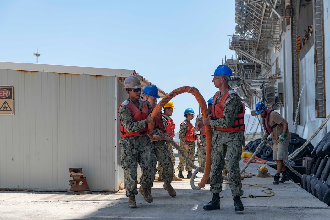 Sailors assigned to Naval Support Activity (NSA) Souda Bay moor amphibious assault ship USS Wasp (LHD 1) at the NATO Marathi Pier Complex in Souda Bay, Greece, during a scheduled port visit on July 8, 2024.