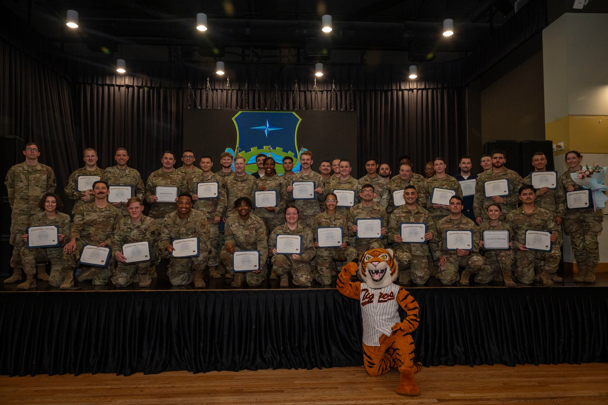 U.S. Air Force Airmen pose for a group photo after a Community College of the Air Force graduation ceremony at Osan Air Base, Republic of Korea, Aug. 2, 2024. The 42 graduates gained their associate's degree, exemplifying their dedication to personal and professional development. (U.S. Air Force photo by Senior Airman Sabrina Fuller-Judd)