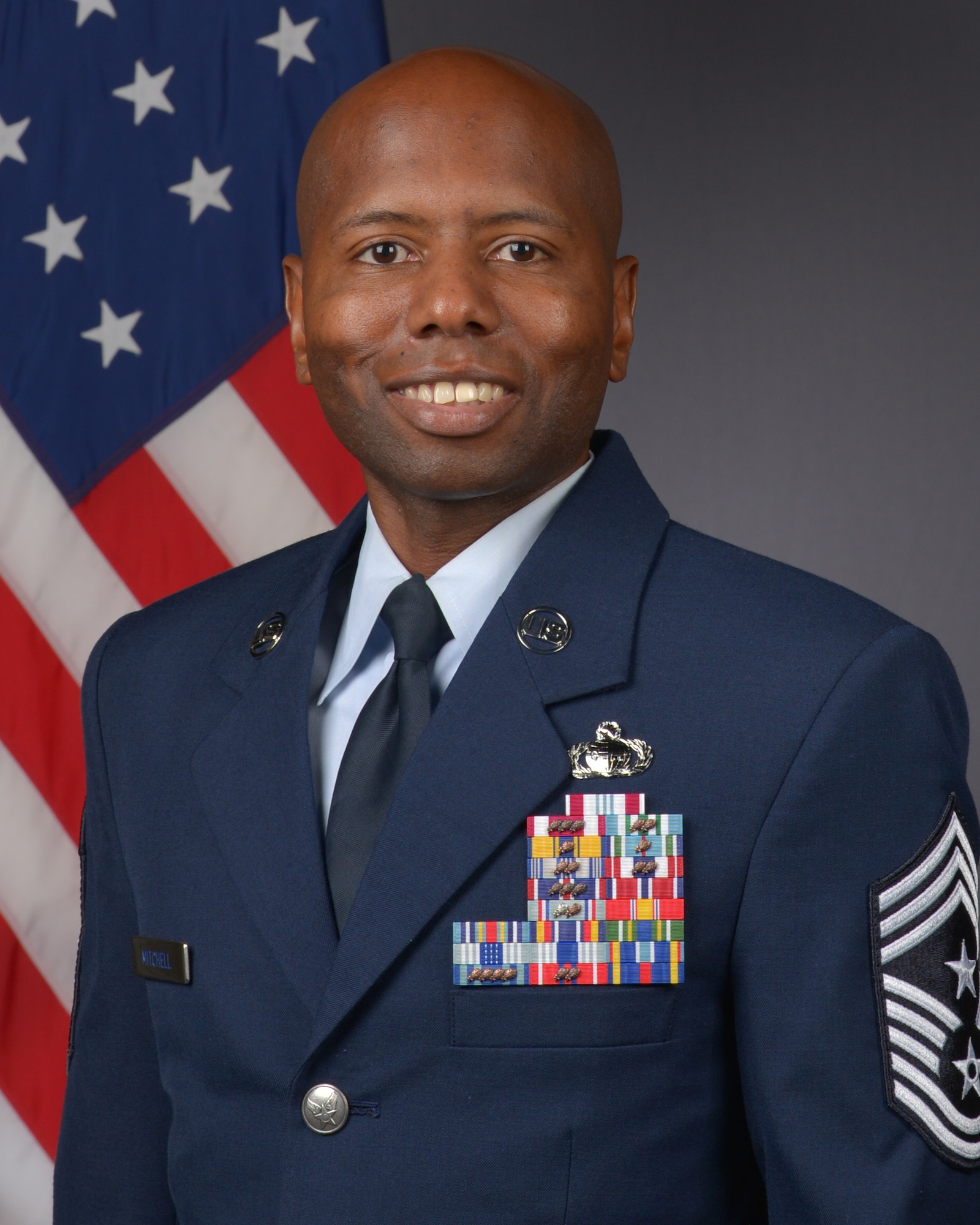 Air Force official photo of an Airman in a blue military suit.