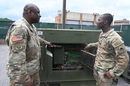 U.S. Army Pfc. James Ray, generator mechanic, and Sgt. Maj. Michael J. Bellamy, Field Maintenance Shop (FMS) 3 supervisor, District of Columbia National Guard, perform an inspection on a generator within the Combined Support Maintenance Shop at Joint Base Anacostia-Bolling (JBAB), June 5, 2024. A native of Washington, D.C, Pfc. Ray enlisted in the Army in 2022, motivated by the travel, connections and skills serving in the National Guard provides him.