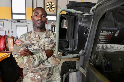 U.S. Army Pfc. James Ray, generator mechanic, 104th Maintenance Company, District of Columbia National Guard, stands for a photograph within the Combined Support Maintenance Shop at Joint Base Anacostia-Bolling (JBAB), June 16, 2024. A native of Washington, D.C, Pfc. Ray enlisted in the Army in 2022, motivated by the travel, connections and skills serving in the National Guard provides him.