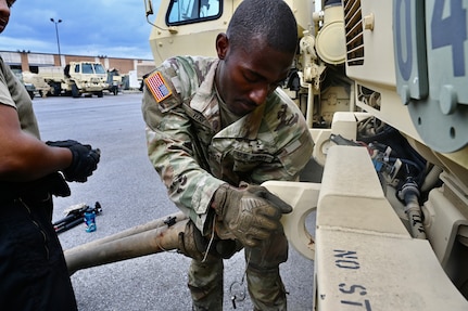 U.S. Army Pfc. James Ray, generator mechanic, 104th Maintenance Company, District of Columbia National Guard, installs a part on a tactical vehicle within the Combined Support Maintenance Shop at Joint Base Anacostia-Bolling (JBAB), June 5, 2024. A native of Washington, D.C, Pfc. Ray enlisted in the Army in 2022, motivated by the travel, connections and skills serving in the National Guard provides him.