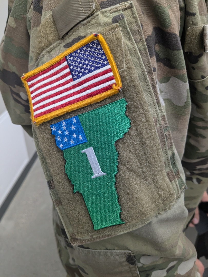 U.S. Army Sgt. Peter Fillion, C Troop, 2nd Squadron, 101st Cavalry Regiment, New York National Guard, displays his competitor patch after receiving the welcome brief for the Army National Guard Best Warrior finals.