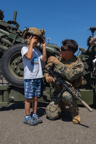 U.S. Marine Corps Lance Cpl. Christopher Mochizuki, right, interacts with a fleet week attendee during Seattle Fleet Week 2024 at Pier 46 in Seattle, Aug. 1, 2024. Seattle Fleet Week is an opportunity for the American public to meet their Navy, Marine Corps and Coast Guard teams and experience America’s sea services. During fleet week, service members participate in various community service events, showcase capabilities and equipment to the community, and enjoy the hospitality of the city and its surrounding areas. (U.S. Marine Corps photo by Cpl. Bruin Largent)