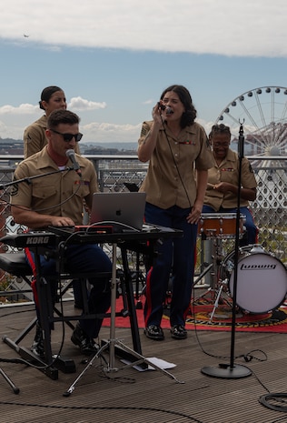 U.S. Marines with 1st Marine Division Band give a public performance at Pike Place Market in Seattle, Washington as part of Seattle Fleet Week July 31, 2024. During fleet week, service members participate in various community service events, showcase capabilities and equipment to the community, and enjoy the hospitality of Seattle and its surrounding areas. (U.S. Marine Corps photo by Cpl. Bruin Largent)