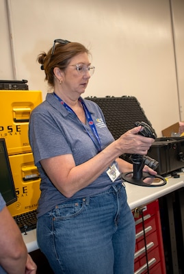 Teacher holds robotic control joystick device