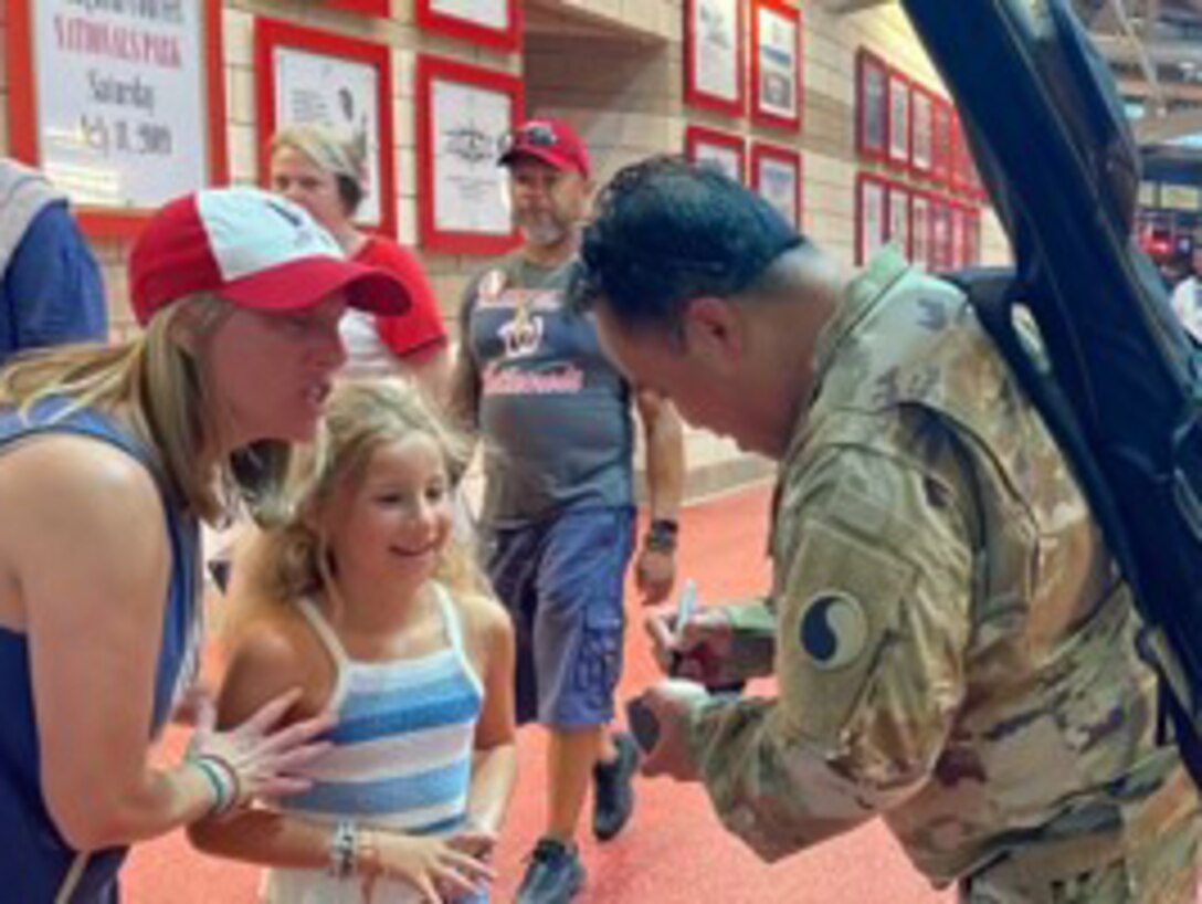 Staff Sgt. Junel Custodio signs autographs after his performance of our National Anthem at the Washington Nationals Baseball Game