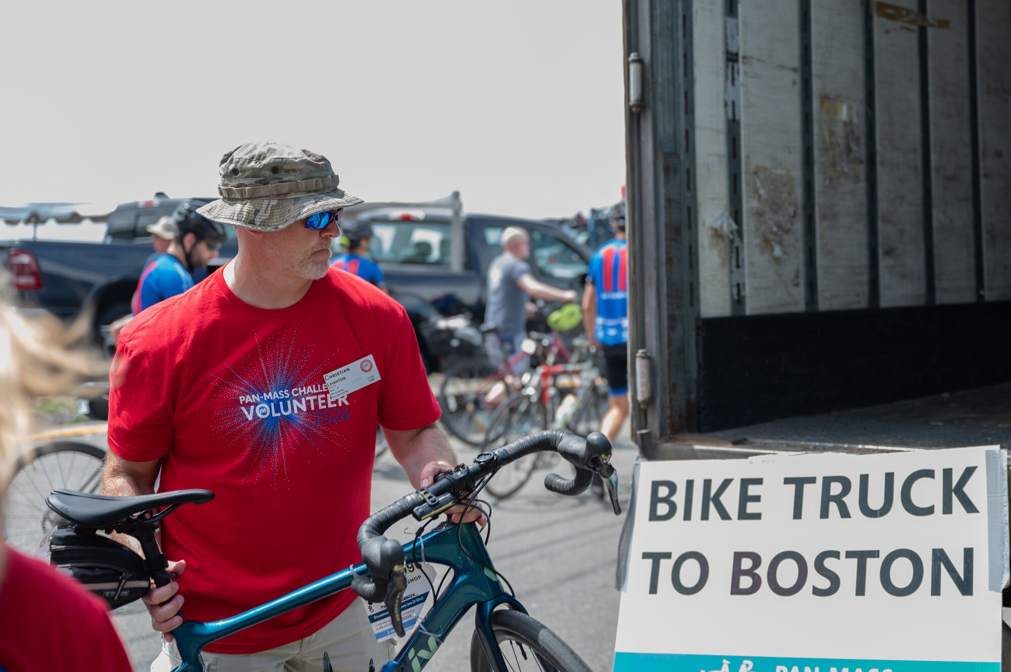Volunteer holds bike.