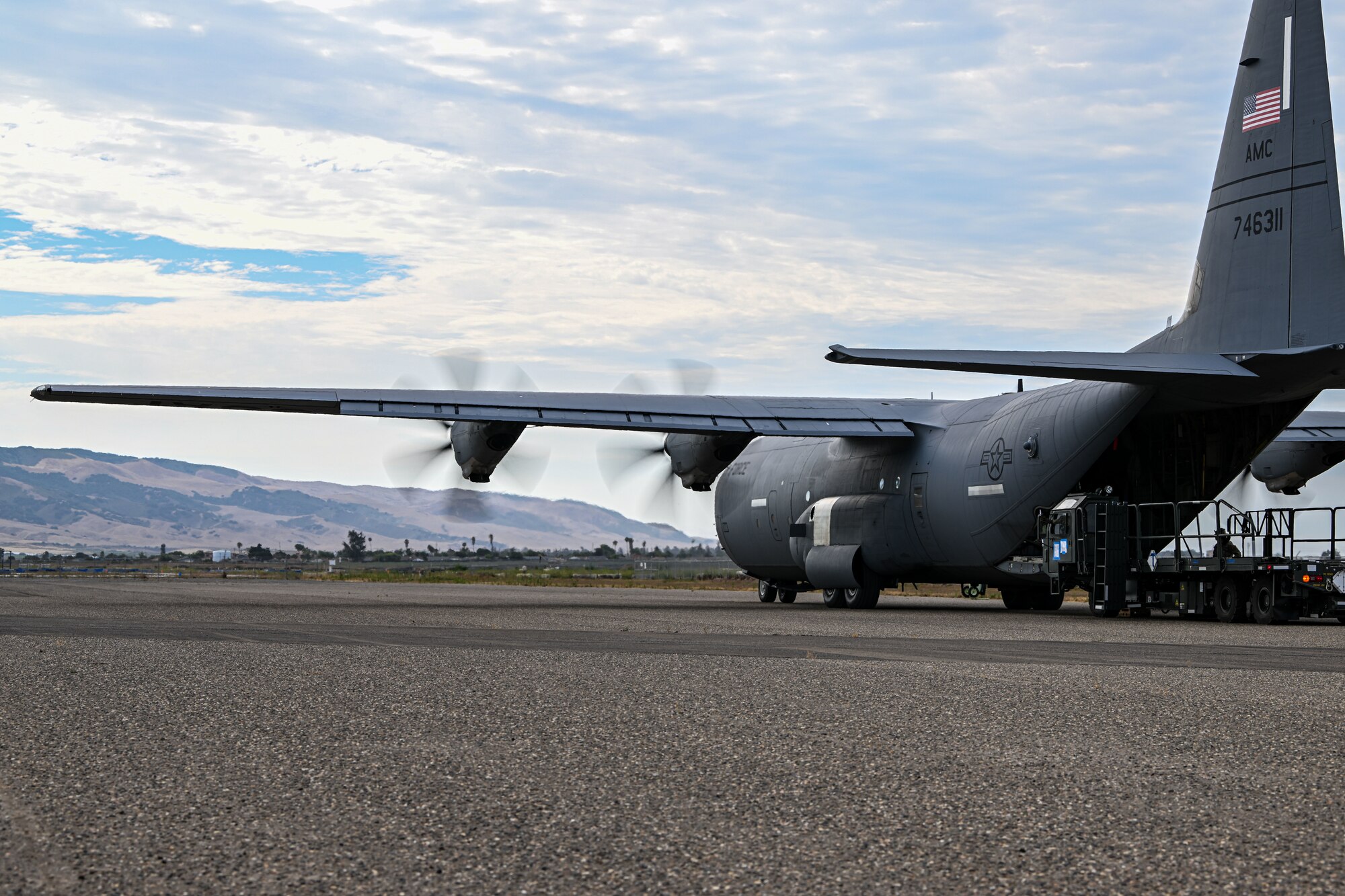 a photo of a c-130 unloading cargo