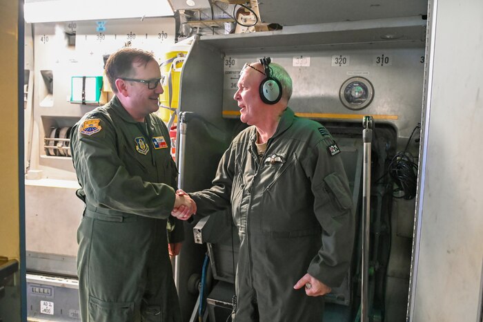 Col. Douglas Jeffrey, 433rd Airlift Wing commander, shakes hands with British Royal Air Force Flight Lieutenant Jamie Teller, a 622 Squadron aircraft captain, during a 433rd Aeromedical Evacuation Squadron training event July 12, 2024 at Joint Base San Antonio-Lackland, Texas.