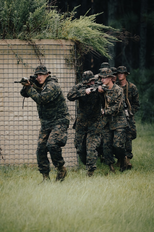 Students with the Naval Reserve Officer Training Corps move to clear a building during Midshipman Summer Training at Marine Corps Base Camp Lejeune, North Carolina, July 25, 2024. Students in the ROTC participated in combat engineer and infantry training to prepare for future military careers. (U.S. Marine Corps photo by Cpl. Yasmine De La Rosa)