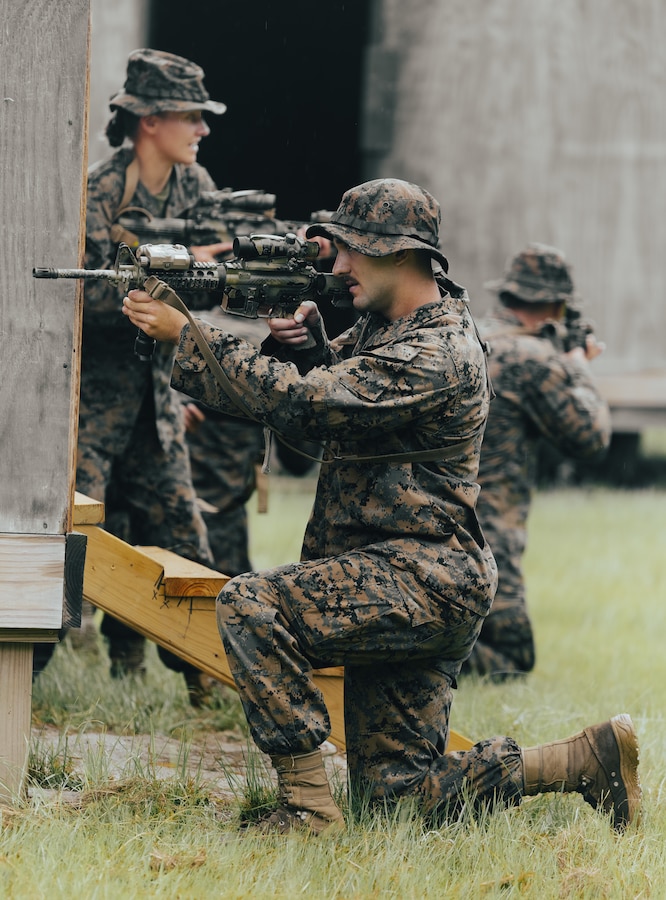 U.S. Naval Reserve Officer Training Corps Midshipman Ayden Sarber and Midshipman 2nd Class Hayden Gregory, both students with the University of Rochester ROTC, participate in a building clearing exercise during Midshipman Summer Training at Marine Corps Base Camp Lejeune, North Carolina, July 25, 2024. Students in the ROTC participated in combat engineer and infantry training to prepare for future military careers. (U.S. Marine Corps photo by Cpl. Yasmine De La Rosa)