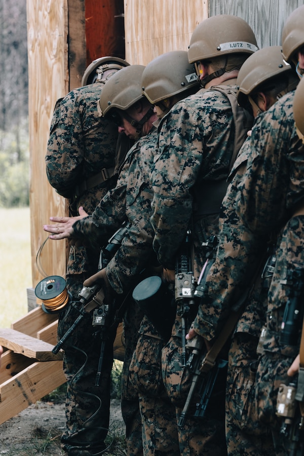 Students with the U.S. Naval Reserve Officer Training Corps detonate an explosive inside of a building during Midshipman Summer Training on Marine Corps Base Camp Lejeune, North Carolina, July 25, 2024. Students in the ROTC participated in combat engineer and infantry training to prepare for future military careers. (U.S. Marine Corps photo by Cpl. Yasmine De La Rosa)