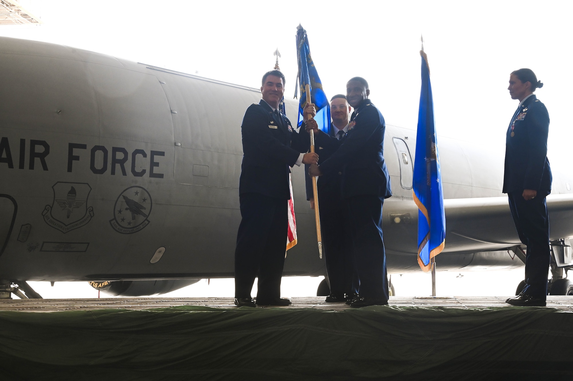 U.S. Air Force Col. John Masterson, 97th Operations Group commander, passes the 54th Air Refueling Squadron (ARS) guidon to Lt. Col. Broderick Lockett, 54th ARS commander, at Altus Air Force Base, Oklahoma, June 21, 2024. The 54th ARS is the sole Air Education and Training Command KC-135 Stratotanker flying training squadron and provides KC-135 initial and advanced flight qualification. (U.S. Air Force photo by Senior Airman Kari Degraffenreed)