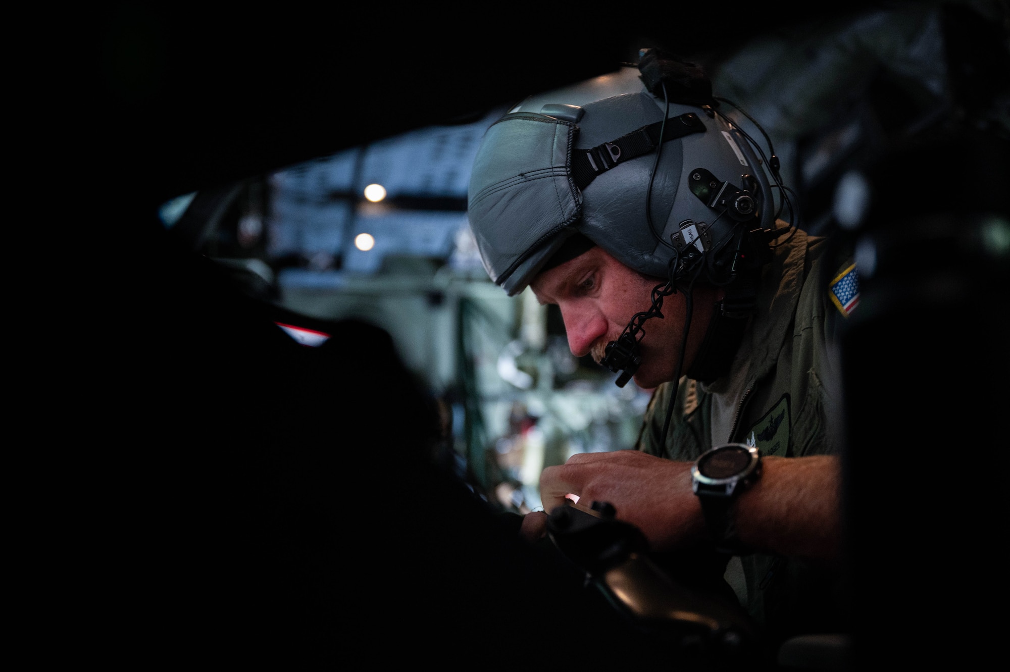 U.S. Air Force Maj. Aaron Magger, a 5th Special Operations Squadron weapons system operator, participates in a live-fire training on board an AC-130J Ghostrider Gunship over Joint Base Elmendorf-Richardson, Alaska, July 19, 2024.