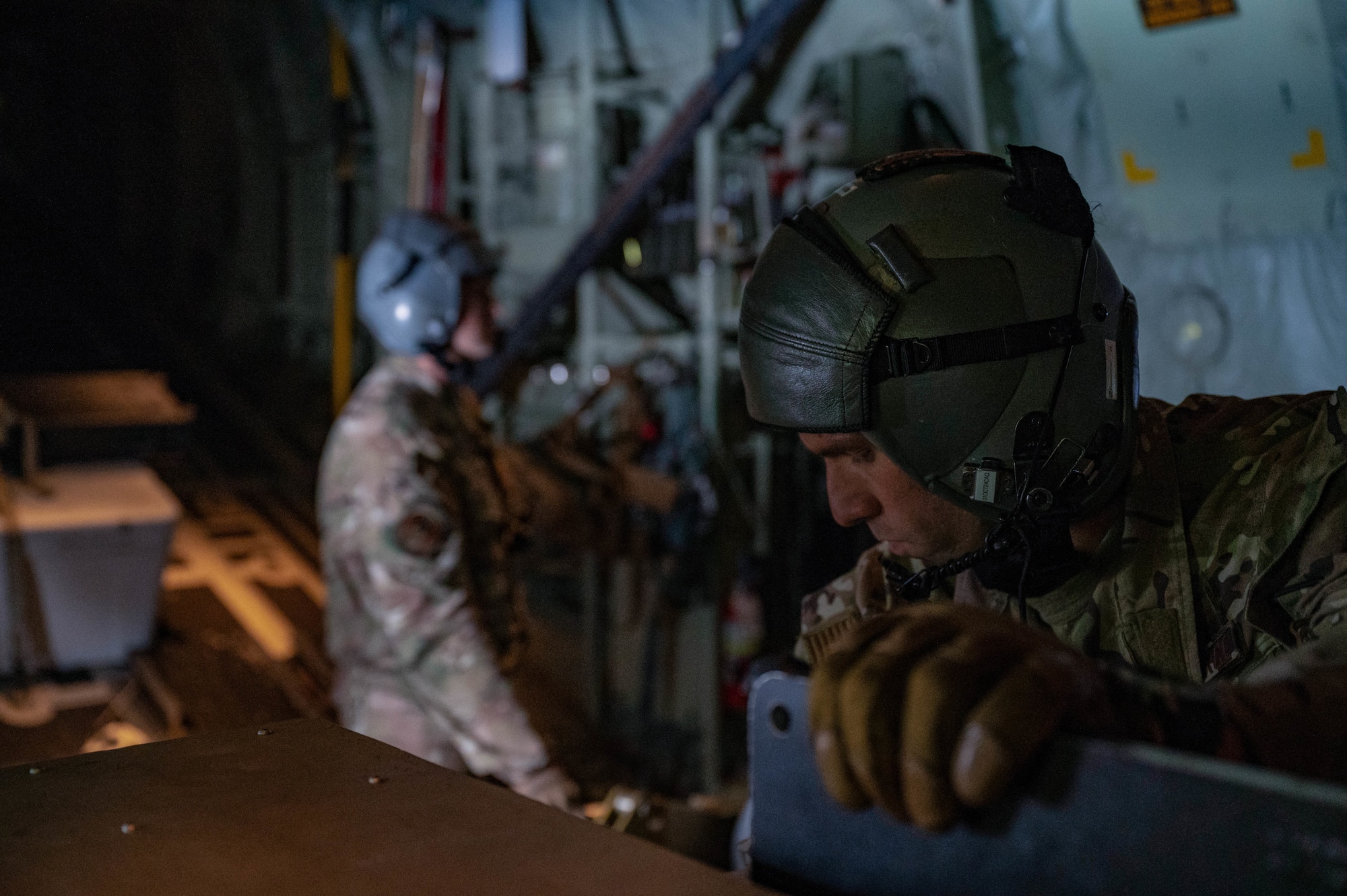 U.S. Air Force Master Sgt. Anthony Nunez, a 5th Special Operations Squadron special missions aviator, prepares to load a round into the 105mm cannon during AC-130J Ghostrider Gunship live-fire training over Joint Base Elmendorf-Richardson, Alaska, July 19, 2024.