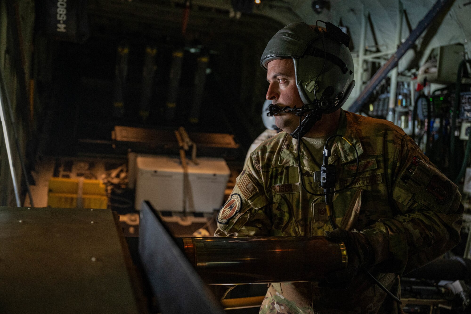 U.S. Air Force Tech Sgt. Thomas Crosby,  a 5th Special Operations Squadron special missions aviator, prepares to load a round into the 105mm cannon during AC-130J Ghostrider Gunship live-fire training over Joint Base Elmendorf-Richardson, Alaska, July 19, 2024.