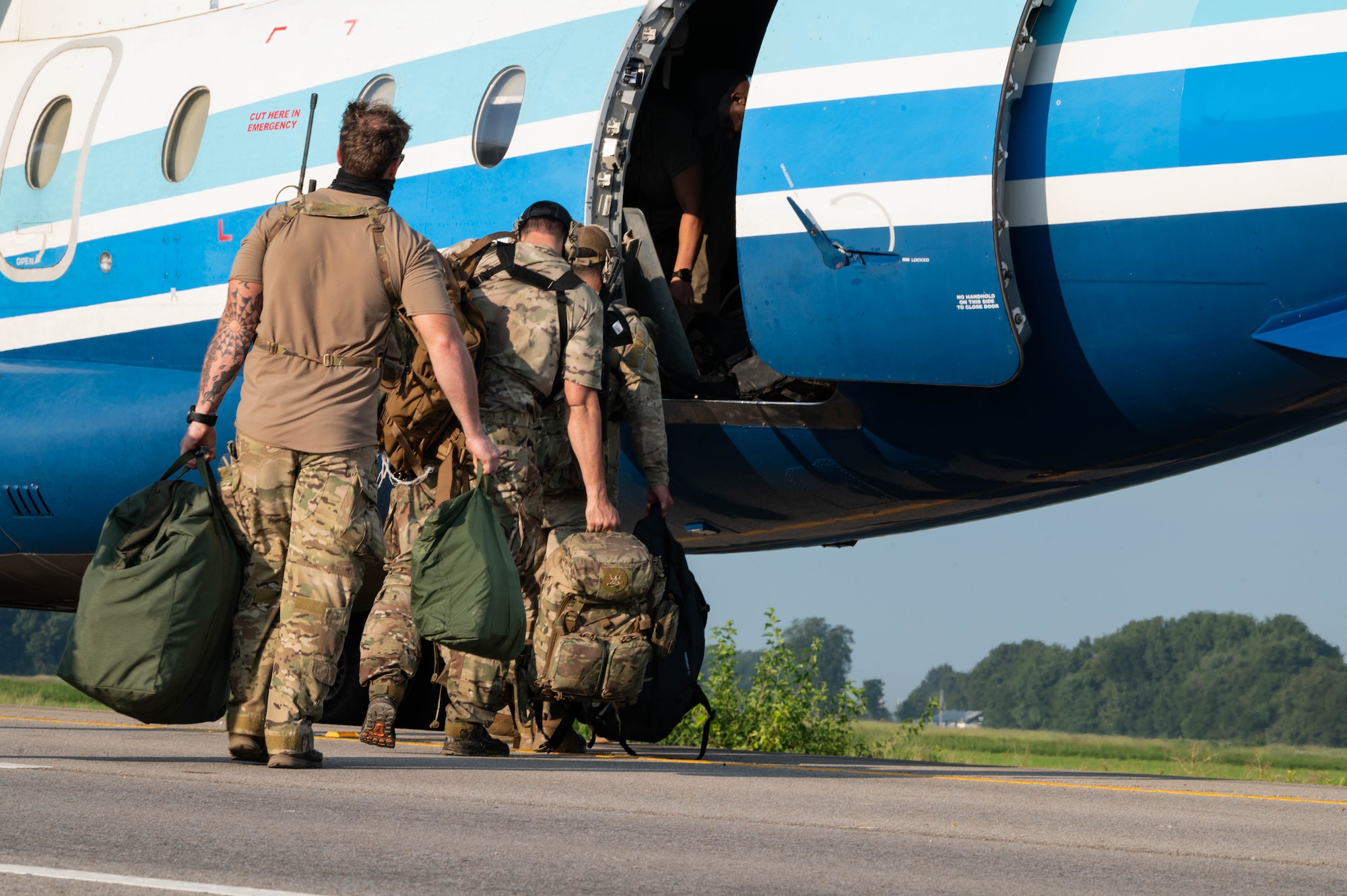 A U.S. Air Force Special Tactics team, assigned to the 1st Special Operations Wing, get into the back of a C-146A Wolfhound, assigned to the 492nd Special Operations Wing, to prepare to exfil from a highway landing during the Emerald Warrior 24 FTX II in Bono, Arkansas, August 4, 2024.