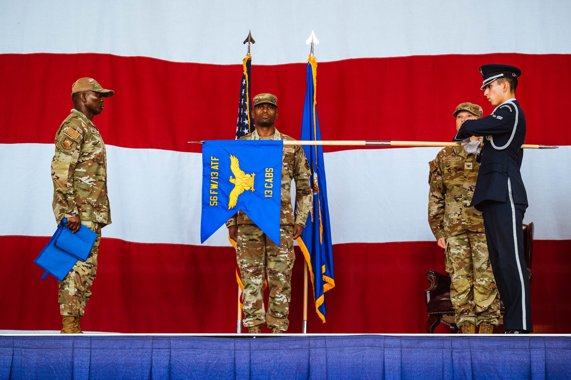 56th Fighter Wing personnel unveil the 13th Combat Air Base Squadron guidon during the 13th CABS assumption of command ceremony, Aug. 5, 2024, at Luke Air Force Base, Arizona.