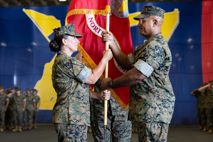 U.S. Marine Corps Lt. Gen. Brian W. Cavanaugh, right, outgoing Commanding General, Fleet Marine Force, Atlantic, Commander, Marine Forces Command, Commander, Marine Forces North, passes the command colors to Lt. Gen. Roberta L. Shea, left, incoming Commanding General, Fleet Marine Force, Atlantic, Commander, Marine Forces Command, Marine Forces North, during a change of command ceremony aboard Wasp-class amphibious assault ship USS Iwo Jima (LHD 7), Naval Station Norfolk, Virginia, Aug. 6, 2024. The change of command ceremony is a military tradition that signifies all responsibilities and authorities being transferred from one commander to another. The new commanding general will proceed to execute the mission of FMFLANT, MARFORCOM and MARFORNORTH in provisioning joint-capable Marine Corps forces, direct deployment planning and execution of service-retained operating forces in support of the combatant commander. (U.S. Marine Corps photo by Casey Price)