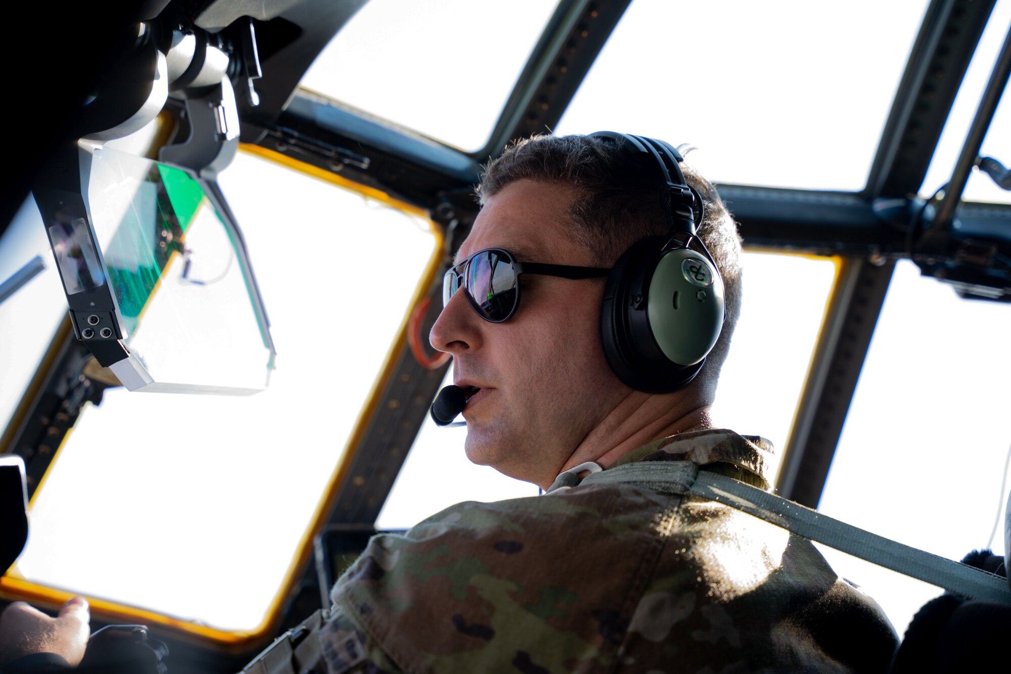 U.S. Air Force Maj. Austin Bohn, 9th Special Operations Squadron aircraft commander, checks aircraft positioning during a flyover at Colorado Springs, Colorado, Aug. 2, 2024. Two 9th SOS MC-130J Commando II aircraft conducted the flyover as Lt. Gen. Tony D. Bauernfeind, previous commander of Air Force Special Operations Command and AFSOC MC-130 pilot, became the 22nd superintendent of the U.S. Air Force Academy in an assumption of command ceremony. (U.S. Air Force photo by Airman 1st Class Gracelyn Hess)