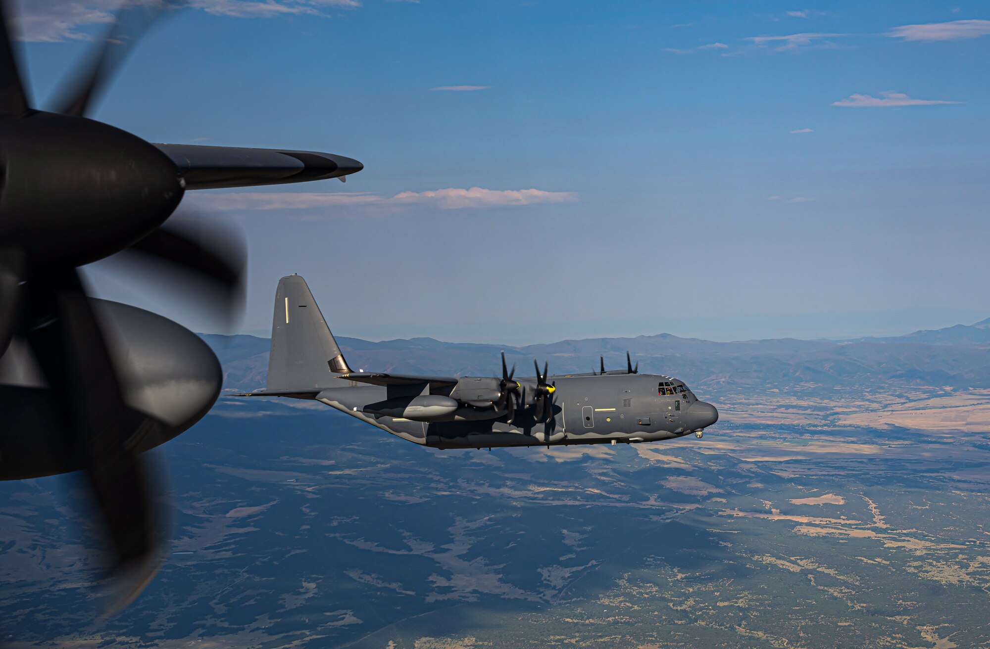 Two MC-130J Commando II aircraft, assigned to the 9th Special Operations Squadron, perform a flyover during the assumption of command ceremony where U.S. Air Force Lt. Gen. Tony D. Bauernfeind became the 22nd U.S. Air Force Academy superintendent, in Colorado Springs, Colorado, Aug. 2, 2024. Bauernfeind has extensive experience as a command pilot, having flown over 3,500 hours on multiple platforms throughout his career, including the MC-130. (U.S. Air Force photo by Airman 1st Class Gracelyn Hess)