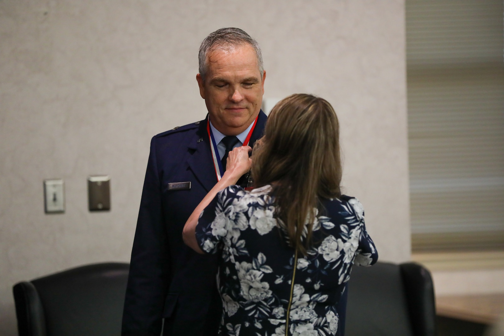 Brig. Gen. Rick L. Mutchler, former chief of staff for the Oklahoma Air National Guard, receives his retirement pin from his wife, Andrea, at Will Rogers Air National Guard Base in Oklahoma City, Aug. 3, 2024. Mutchler served in numerous critical roles, from his position as chief of supply at Will Rogers ANG Base to his most recent role as OKANG chief of staff, he consistently demonstrated exceptional leadership and dedication. (Oklahoma National Guard photo by Sgt. Connor McBride)