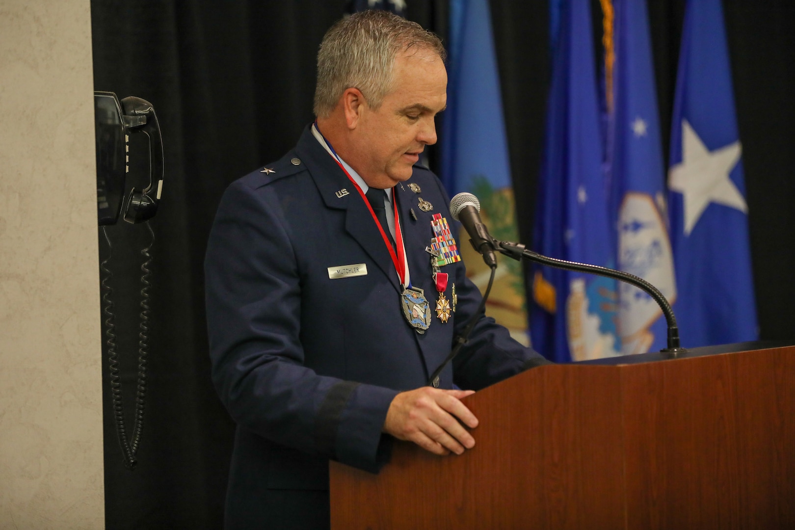 Brig. Gen. Rick L. Mutchler, former chief of staff for the Oklahoma Air National Guard, gives remarks to his friends, family, and fellow Airmen at his retirement ceremony, Oklahoma City, Aug. 3, 2024. Mutchler served in numerous critical roles, from his position as chief of supply at Will Rogers ANG Base to his most recent role as OKANG chief of staff, he consistently demonstrated exceptional leadership and dedication. (Oklahoma National Guard photo by Sgt. Connor McBride)