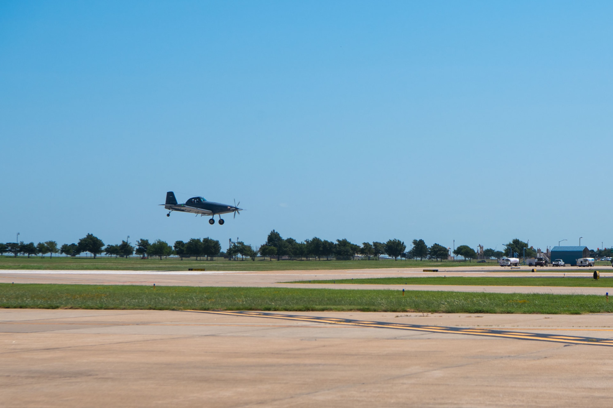 An AT-802U trainer aircraft lands on the flightline