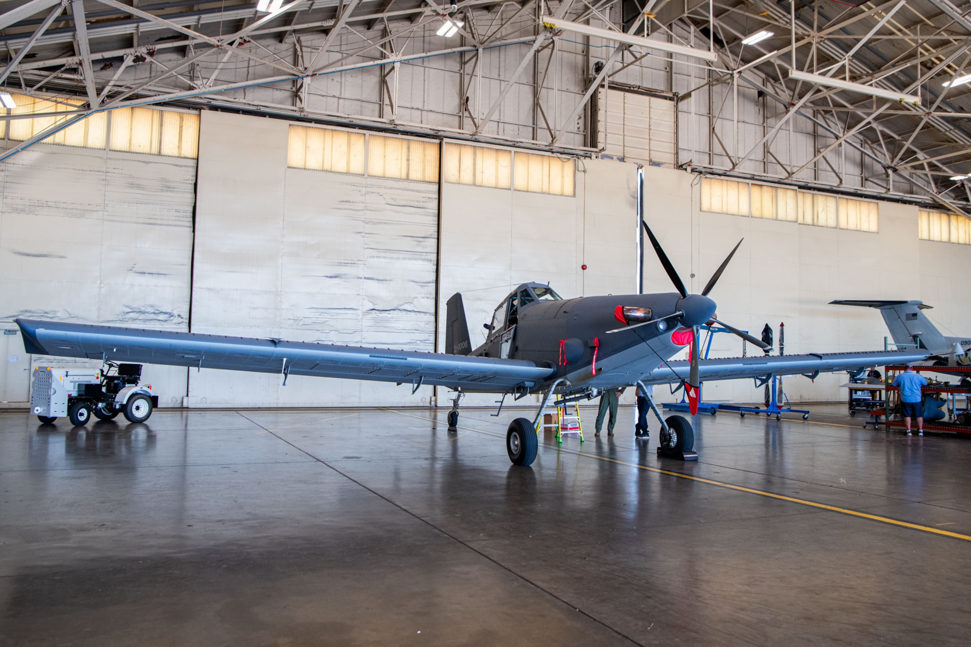 an AT-802U tail wheel aircraft sits in an aircraft hanger