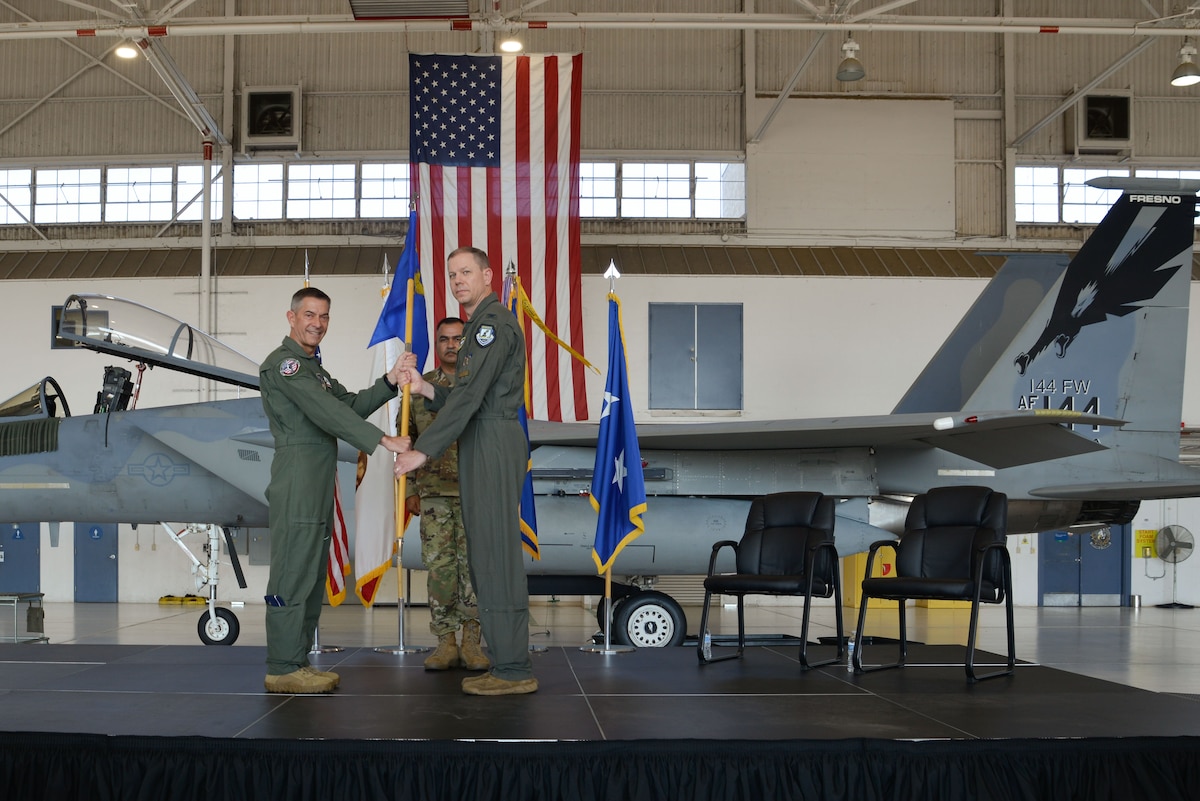 U.S. Air Force Col. Joel Pauls accepts the 144th Fighter Wing guidon from U.S. Air Force Maj. Gen. Steven Butow, California Air National Guard commander, during an assumption of command ceremony, Aug. 4, 2024, at the Fresno Air National Guard Base, Calif.