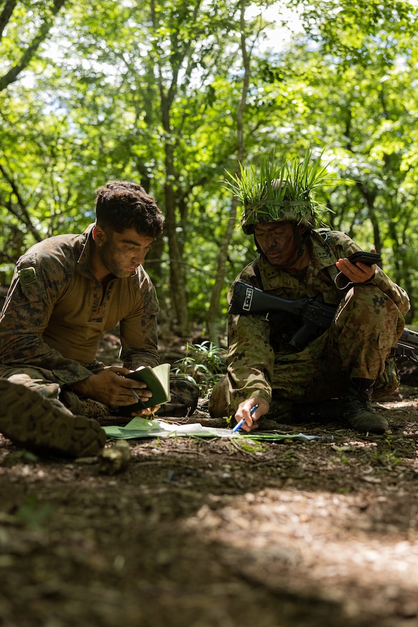 U.S. Marine Corps 1st Lt. Dante DeBonis, left, and a Japan Ground Self-Defense Force member plan their next defensive position during exercise Resolute Dragon 24 at Japan Ground Self-Defense Force Hijudai Maneuver Area, Oita Prefecture, Japan, July 31, 2024. RD 24 is an annual bilateral exercise in Japan that strengthens the command, control and multi-domain maneuver capabilities of U.S. Marines in III Marine Expeditionary Force and Japan Self-Defense Force personnel with a focus on controlling and defending key maritime terrain. De Bonis, a native of New York, is an infantry officer with 4th Marine Regiment, 3d Marine Division. (U.S. Marine Corps photo by Lance Cpl. Kendrick Jackson)