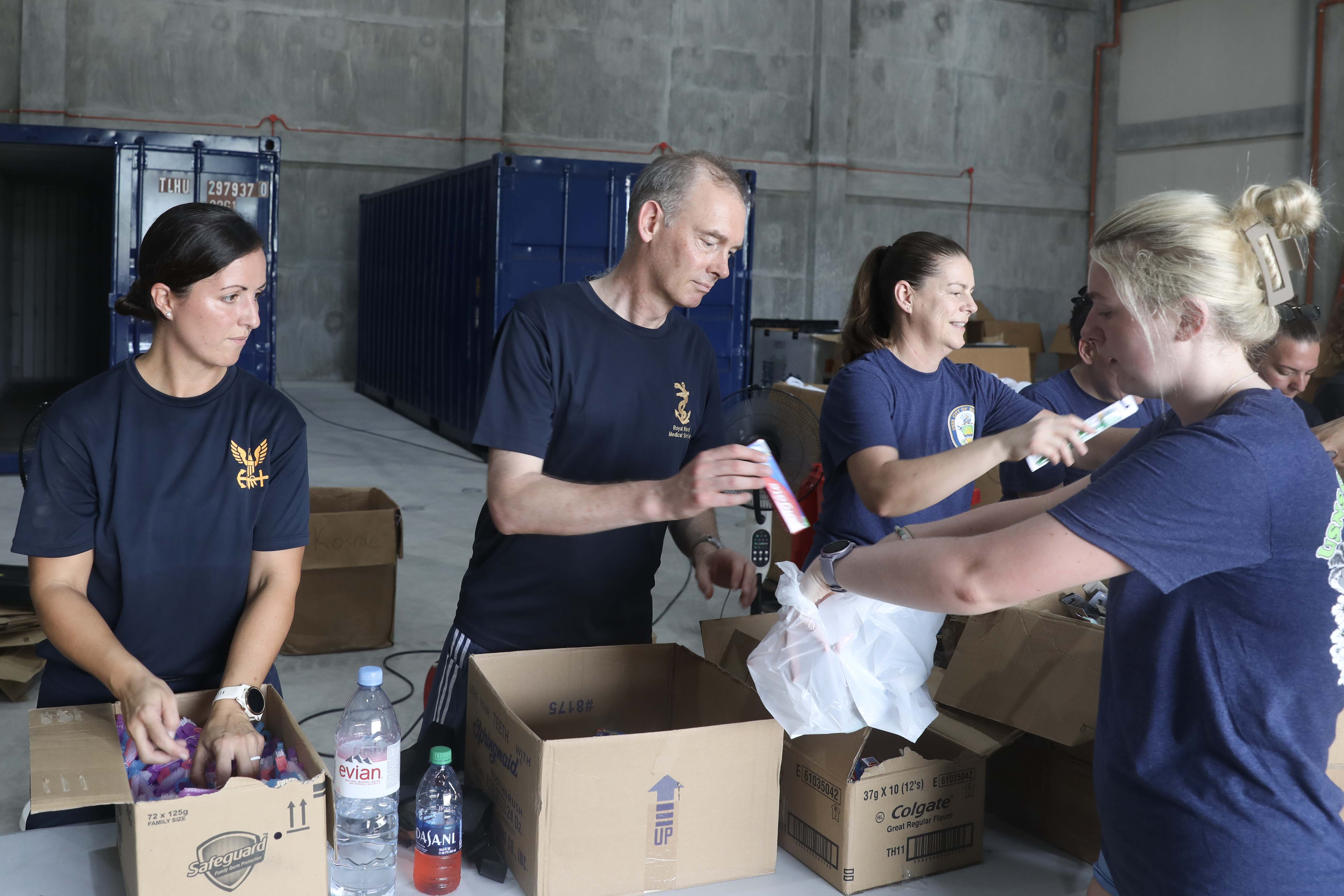 LEGAZPI, Philippines (Aug. 1, 2024) – Left to right, Australian Army Nursing Officer Lt. Chloe Apps, U.S. Navy Cmdr. Hannah Hooten, of Memphis, Tenn., and Royal Navy Surg. Cdr. James Shelley, fill a bag carried by Royal Navy Leading Naval Nurse Shannon Joy with hygiene items on an assembly line in Legazpi, Philippines, Aug. 1, 2024. The 4,000 plus hygiene kits will be handed out to students while conducting health fairs at five elementary schools throughout Legazpi as part of the medical line of effort for Pacific Partnership 24-2. Now in its 20th iteration, the Pacific Partnership series is the largest annual multinational humanitarian assistance and disaster relief preparedness mission conducted in the Indo-Pacific. Pacific Partnership works collaboratively with host and partner nations to enhance regional interoperability and disaster response capabilities, increase security and stability in the region, and foster new and enduring friendships in the Indo-Pacific. (U.S. Navy photo by Mass Communication Specialist 1st Class Ryan D. McLearnon/Released)