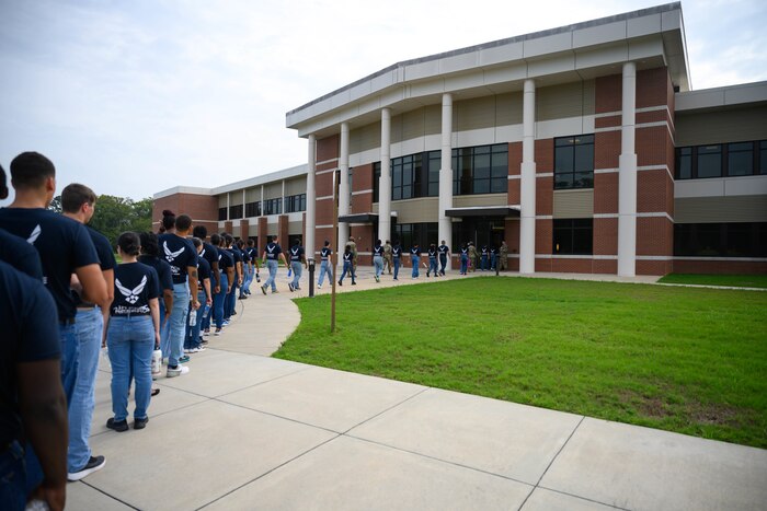 Development and Training Flight trainees stand in a single-line formation as they prepare to enter Air Force Reserve Command headquarters during their unit training assembly weekend immersion tour of AFRC, Robins Air Force Base, Ga. Aug. 3, 2024.