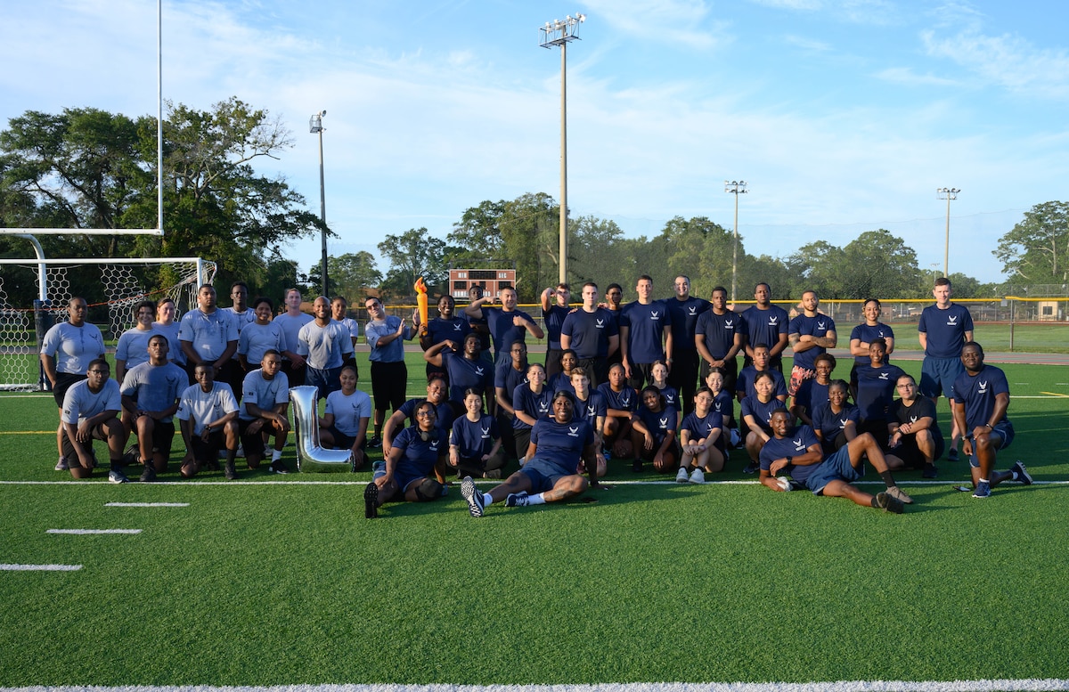 Development and Training Flight trainees assigned to the 315th Airlift Wing, Joint Base Charleston, S.C. and 908th Flying Training Wing, Maxwell Air Force Base, Ala., pose with recruiting and D&TF leadership after performing early morning physical training during their unit training assembly immersion tour of Air Force Reserve Command, Robins Air Force Base, Ga. Sunday, Aug. 4, 2024.