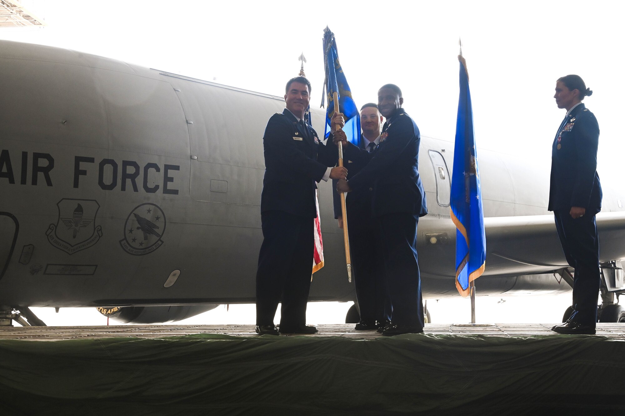 U.S. Air Force Col. John Masterson, 97th Operations Group commander, passes the 54th Air Refueling Squadron (ARS) guidon to Lt. Col. Broderick Lockett, 54th ARS commander, at Altus Air Force Base, Oklahoma, June 21, 2024. The 54th ARS is the sole Air Education and Training Command KC-135 Stratotanker flying training squadron and provides KC-135 initial and advanced flight qualification. (U.S. Air Force photo by Senior Airman Kari Degraffenreed)