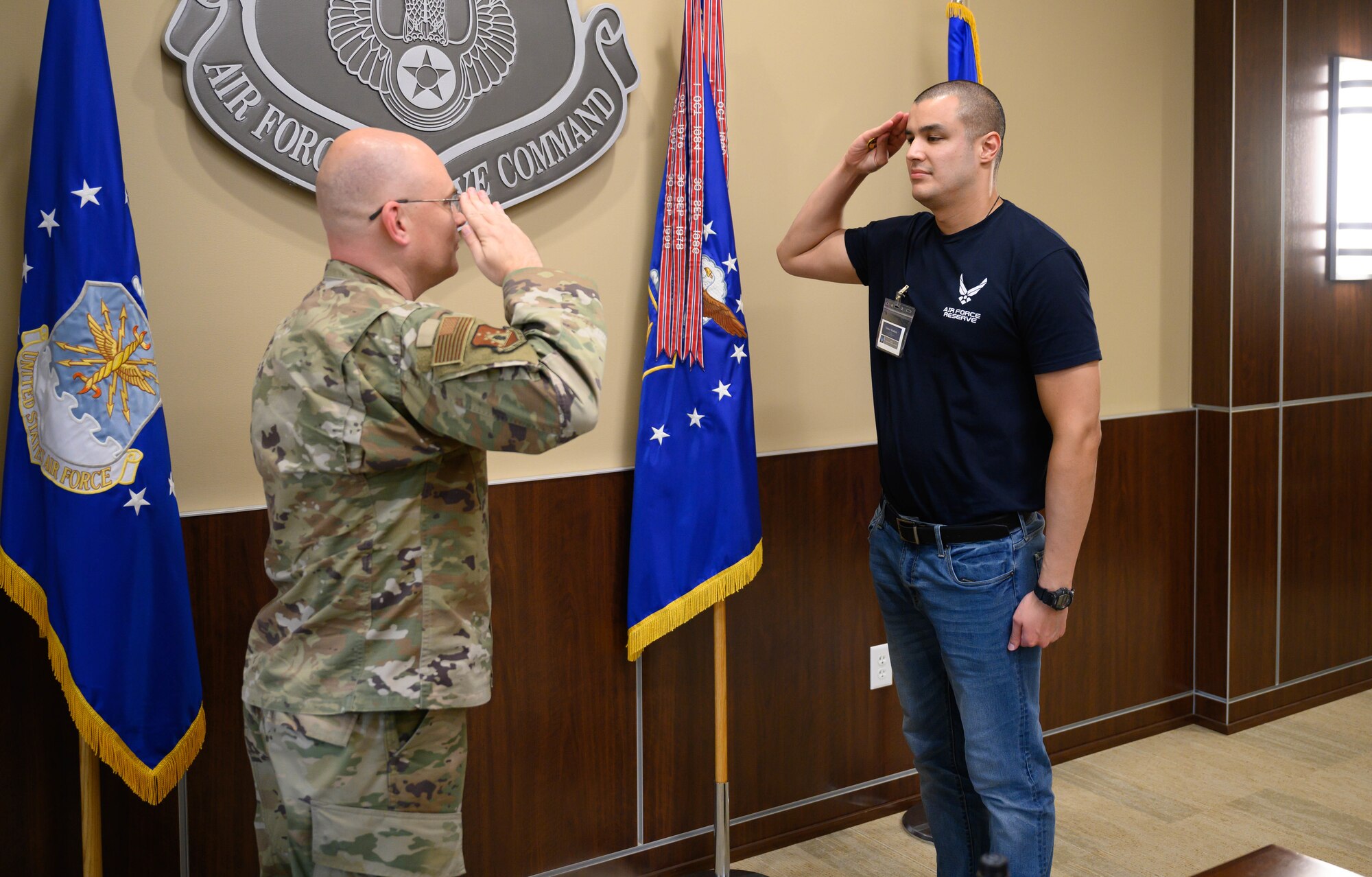 Lt. Col. Jon Quinlan, deputy commander, 367th Recruiting Group, Air Force Reserve Command, recognizes a Development and Training Flight trainee with a ceremonial ‘challenge coin’ for exemplary performance during his unit training assembly weekend immersion tour of AFRC, Robins Air Force Base, Ga. Aug. 3, 2024.
