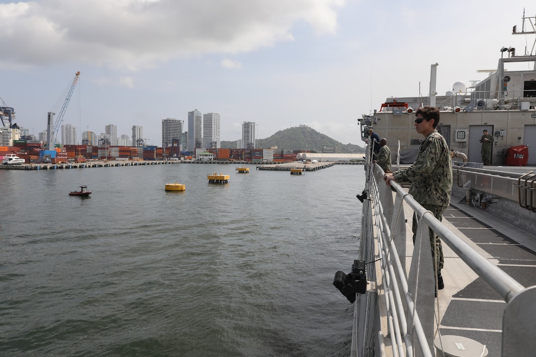 Lt. Rachel Rosedale, a family physician assigned to Naval Medical Center Portsmouth, looks on as expeditionary fast transport ship USNS Burlington (T-EPF 10) pulls into port in Cartagena, Colombia as part of Continuing Promise 2024.