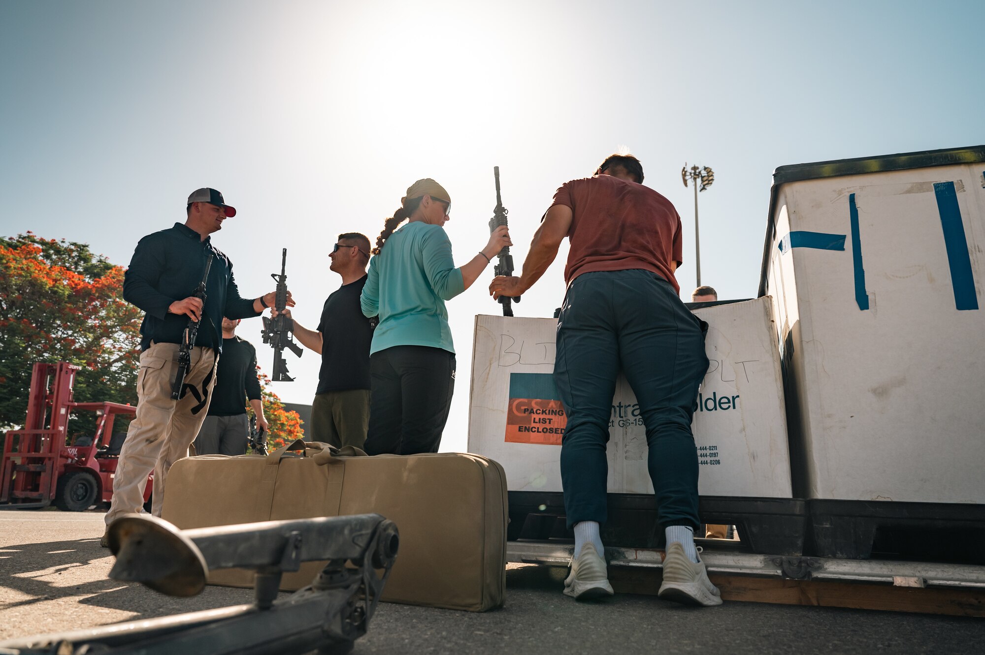 Aerial porters from the 387th Air Expeditionary Squadron’s Quick Reaction Team load weapons into a crate.
