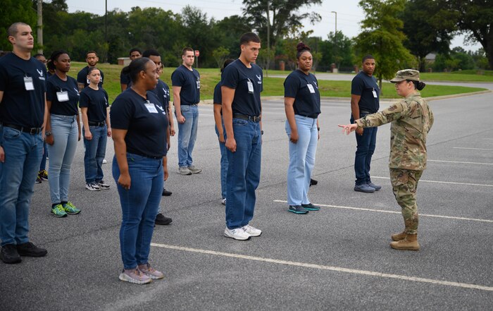 Master Sgt. Danielle Larios, executive assistant to the Air Force Reserve Command command chief master sergeant and Development and Training Flight program manager, reviews drill positions and movements with trainees during their unit training assembly weekend immersion tour of Air Force Reserve Command headquarters, Robins Air Force Base, Ga. Aug. 3, 2024.