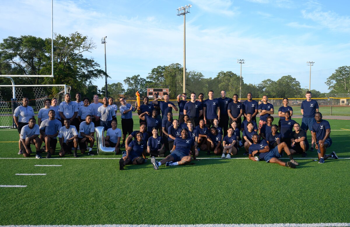 Development and Training Flight trainees assigned to the 315th Airlift Wing, Joint Base Charleston, S.C. and 908th Flying Training Wing, Maxwell Air Force Base, Ala., pose with recruiting and D&TF leadership after performing early morning physical training during their unit training assembly immersion tour of Air Force Reserve Command, Robins Air Force Base, Ga. Sunday, Aug. 4, 2024.