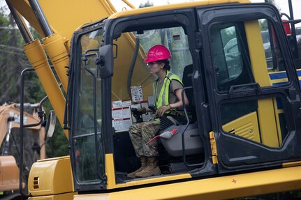 Alaska Army National Guard Spc. Avigale Trevino, a horizontal construction engineer assigned to the 910th Engineer Support Company, operates an excavator on the Alcantra road realignment project during annual training at the Alcantra Armory, Wasilla, Alaska, July 22, 2024. The engineers improved vehicle and personnel access to the armory.