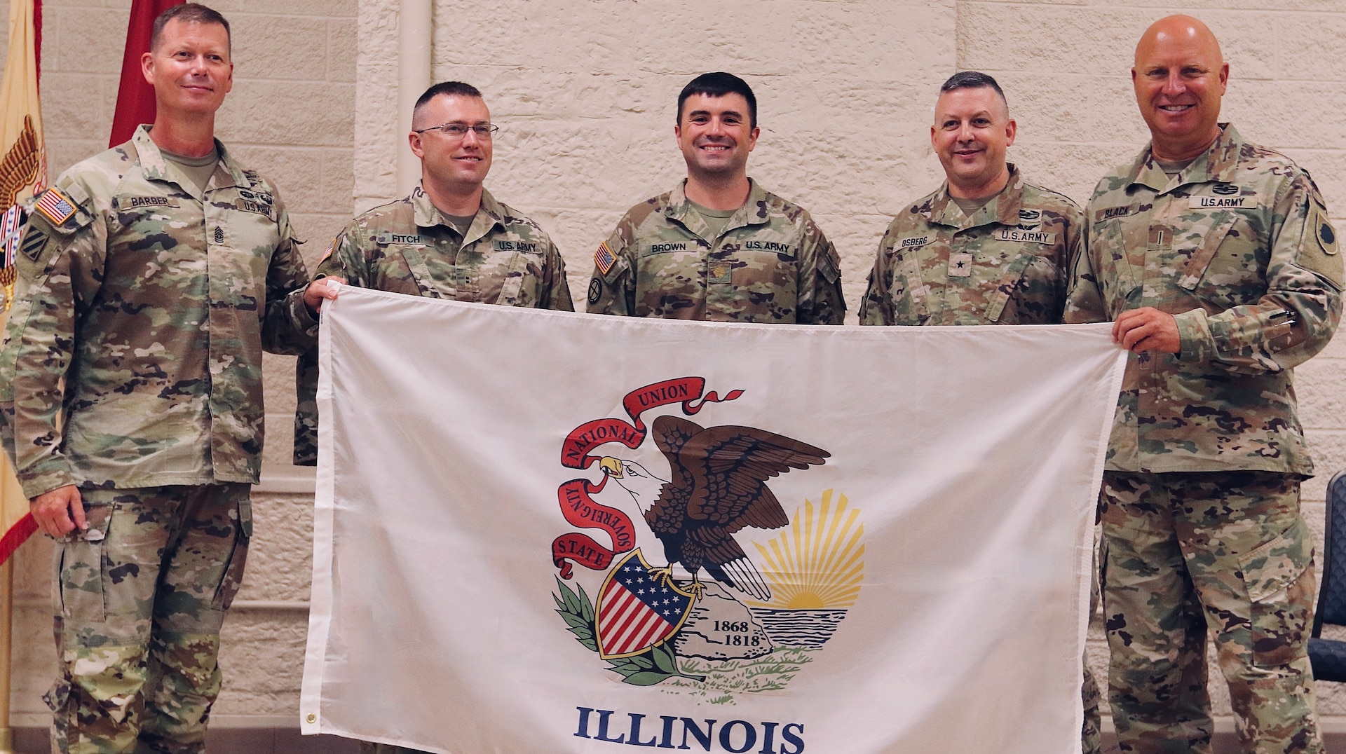 Brig. Gen. Justin Osberg presented the Soldiers of Logistics Advisor Team 6620 with an Illinois State Flag to carry on the team's deployment to Africa. Pictured from left on Aug. 4, 2024, is State Command Sgt. Maj. Phillip Barber, Logistics Advisor Chief Warrant Officer 2 Christopher Fitch, Team Leader Maj. Walter Brown, Osberg, and State Command Chief Warrant Officer Chief Warrant Officer 5 Tom Black.